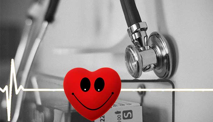 red smile heart with stethoscope in background.