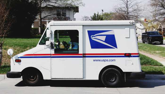 United States Postal truck parked on street.